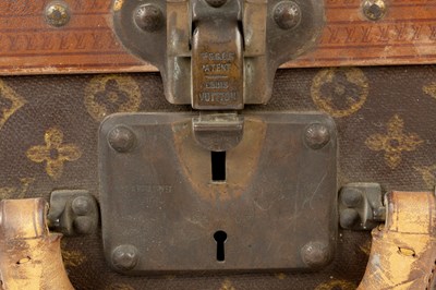 Lot 147 - A Louis Vuitton suitcase, with studded leather...