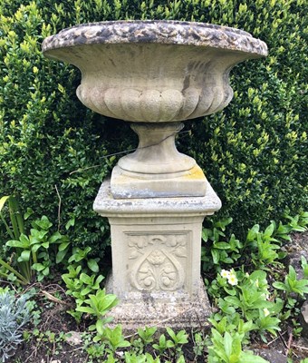 Lot 1367 - A cast reconstituted stone garden urn