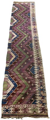 Lot 304 - An antique Kilim runner with purple, green and...