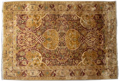 Lot 303 - A late 20th century eastern red ground rug...