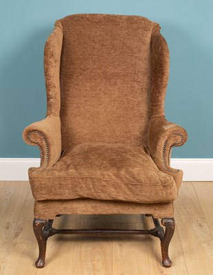 Lot 140 - A Georgian-style wing back upholstered armchair