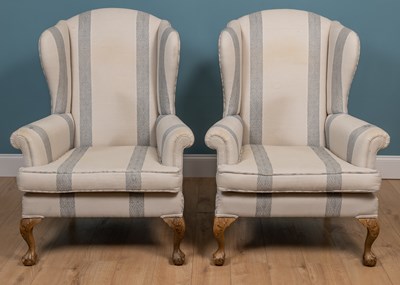 Lot 150 - A pair of Georgian style cream upholstered wing back armchairs
