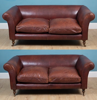 Lot 160 - A pair of maroon leather upholstered two seater settees