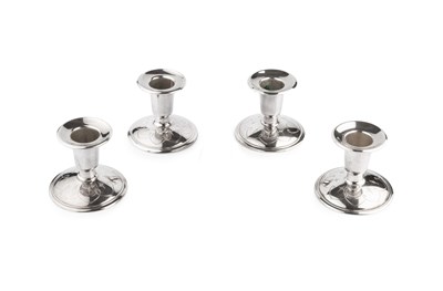 Lot 588 - A set of four silver dwarf candlesticks, the...