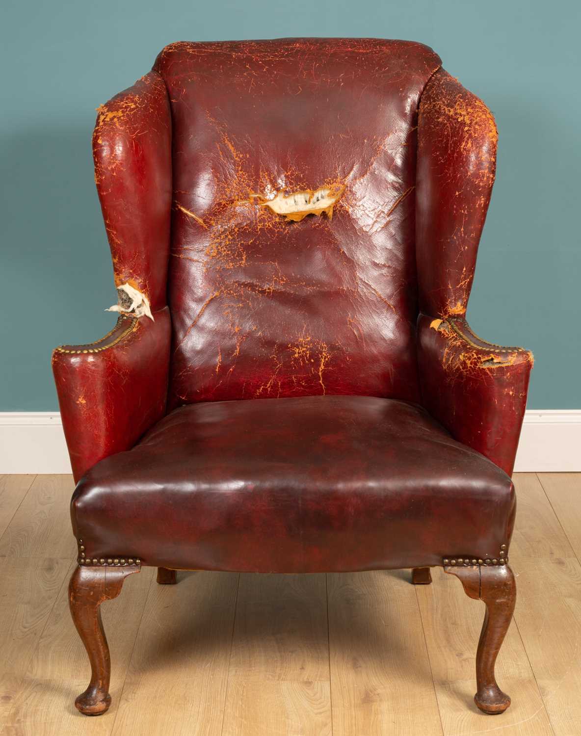 Lot 455 - An 18th century style wing back armchair