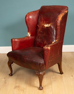 Lot 455 - An 18th century style wing back armchair