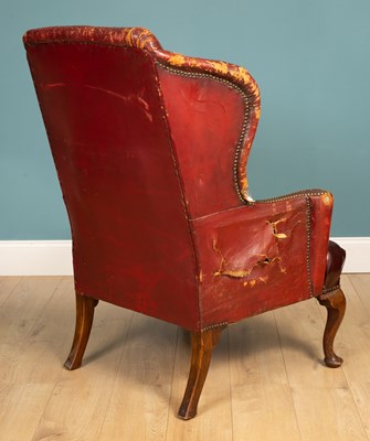 Lot 455 - An 18th century style wing back armchair