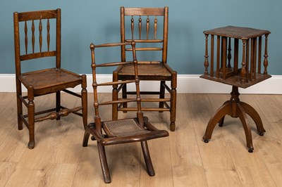 Lot 365 - An oak rotating bookcase; two ash and elm North Country dining chairs; and a folding hardwood chair