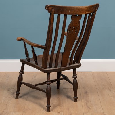 Lot 414 - An antique ash and elm Windsor armchair with splat pierced with initials 'IB'