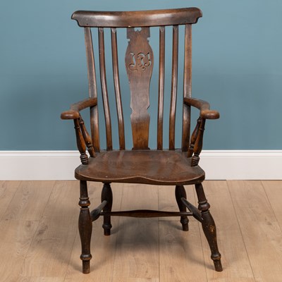 Lot 211 - An antique ash and elm Windsor armchair with splat pierced with initials 'IB'