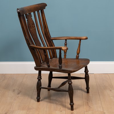 Lot 414 - An antique ash and elm Windsor armchair with splat pierced with initials 'IB'