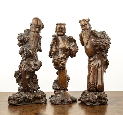 Lot 380 - Three carved wooden figures on bases Chinese,...