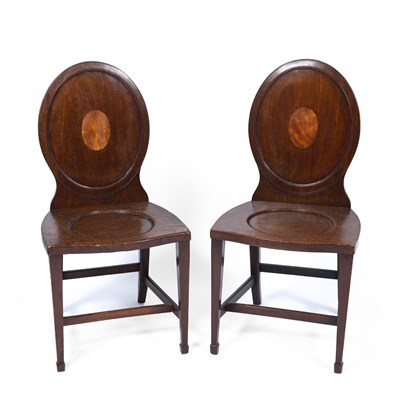 Lot 192 - A pair of Georgian hall chairs with oval backs...