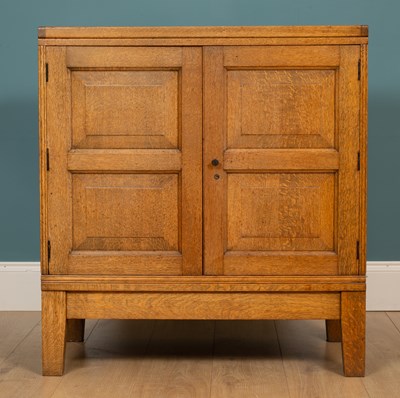 Lot 244 - An early 20th century oak Cotswold school style cabinet