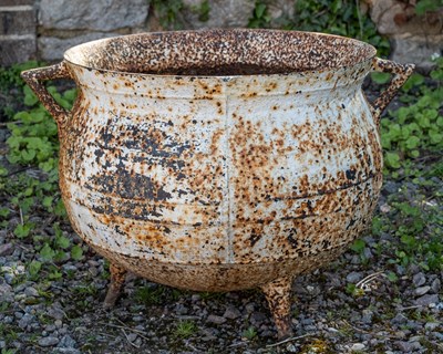 Lot 237 - A cauldron-shaped cast iron planter pot