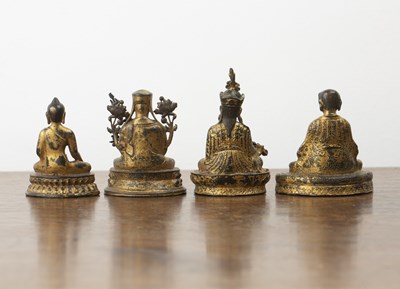 Lot 372 - Group of four small gilt bronze deity figures...