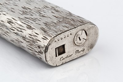 Lot 506 - A silver lighter by Cartier, the rounded...