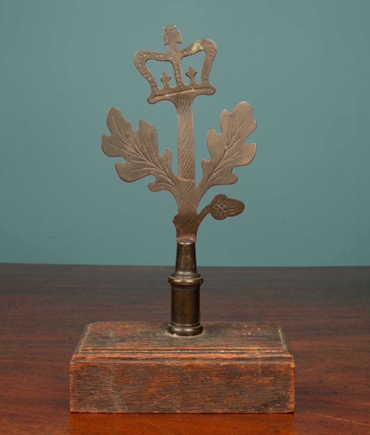 Lot 102 - A brass and oak paperweight