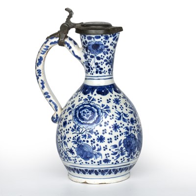 Lot 344 - A Dutch delft blue and white jug with a pewter...