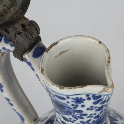 Lot 344 - A Dutch delft blue and white jug with a pewter...