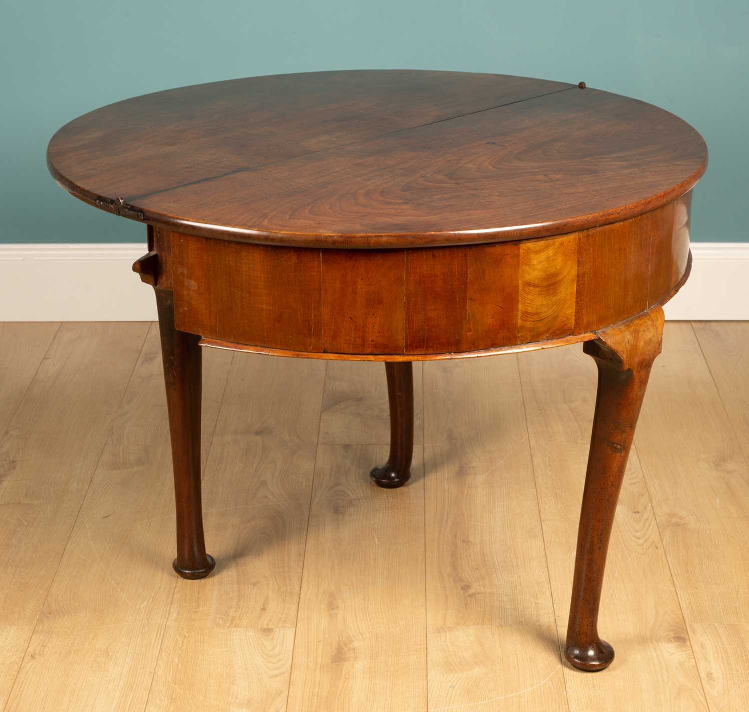 Lot 53 - A George II mahogany demi-lune foldover tea table