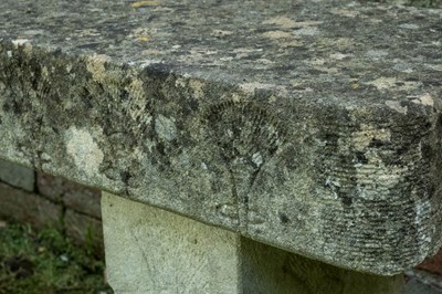 Lot 1358 - A carved stone bench with foliate designs