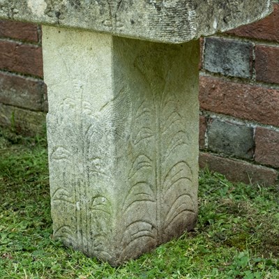 Lot 1358 - A carved stone bench with foliate designs