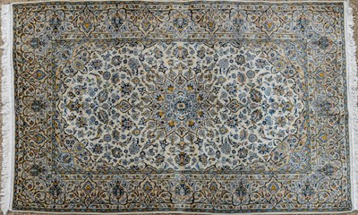 Lot 1053 - A very light green or cream ground fine Kashan rug