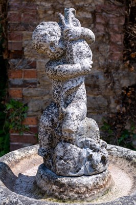 Lot 1349 - A carved marble fountain surmounted by a boy holding a fish