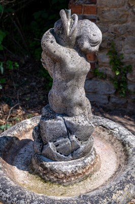Lot 1349 - A carved marble fountain surmounted by a boy holding a fish