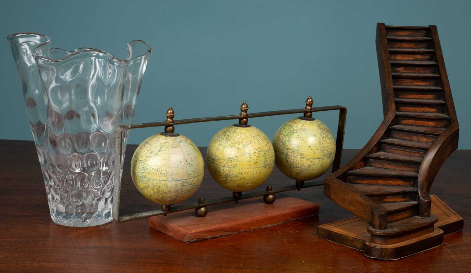 Lot 25 - A hardwood staircase model; a set of three globes; and a glass vase