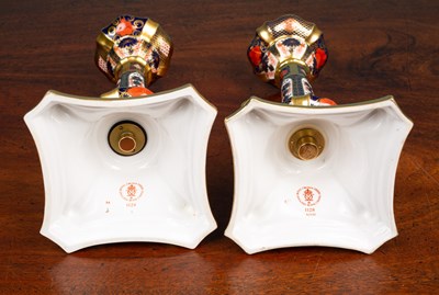 Lot 93 - A pair of Royal Crown Derby porcelain candlesticks
