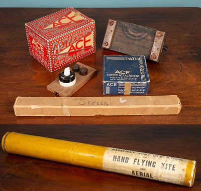 Lot 455 - A Pathéscope "ACE" Home Projector with two 9.5mm Pathéscope films; together with an early emergency hand flying kite