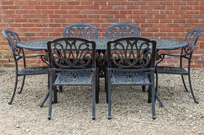 Lot 1257 - A cast aluminium garden table with pierced top; six matching armchairs; and a parasol