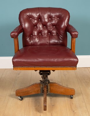 Lot 346 - A leather upholstered rotating desk chair