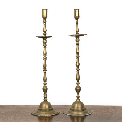 Lot 419 - Pair of brass altar candlesticks on knopped...