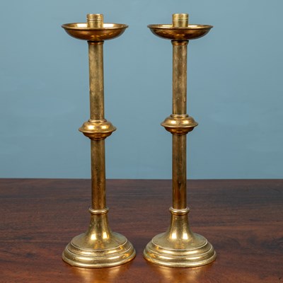 Lot 520 - A pair of brass candlesticks