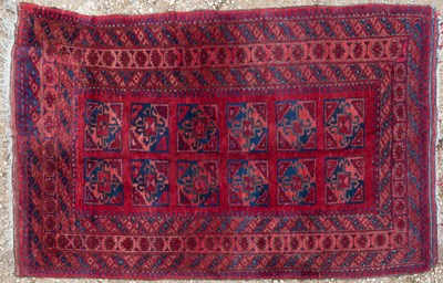 Lot 1050 - An Oriental red ground rug