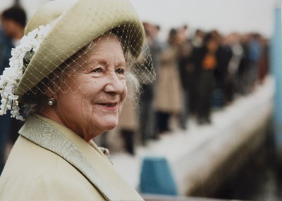 Lot 597 - A folio containing photographs of Queen...