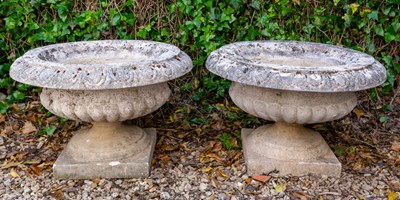 Lot 1336 - A set of four cast reconstituted stone shallow campana urns