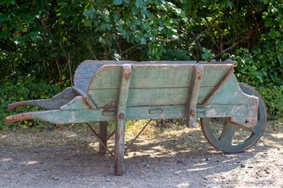 Lot 1304 - An old wooden green painted garden wheelbarrow