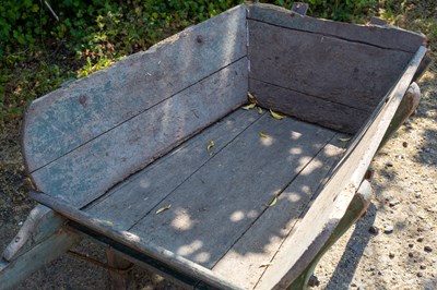 Lot 1304 - An old wooden green painted garden wheelbarrow