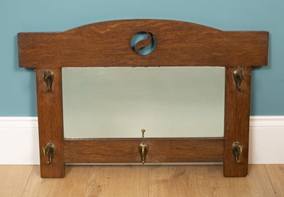 Lot 330 - An Arts & Crafts oak hanging hall mirror