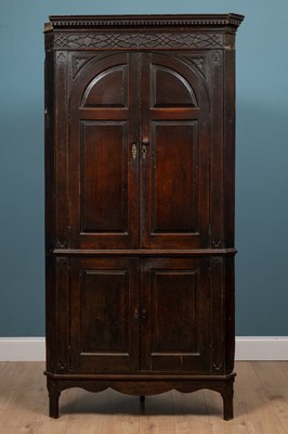 Lot 553 - An 18th century oak corner cupboard