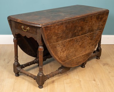 Lot 228 - An 18th century eight-seater oak oval gate leg table