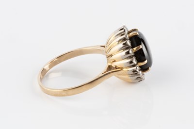 Lot 24 - A black star sapphire and diamond cluster ring,...