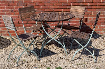 Lot 1261 - A circular garden table together with a set of four matching chairs