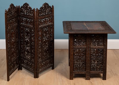 Lot 566 - An Anglo-Indian carved hardwood folding table together with a matching three-fold small screen