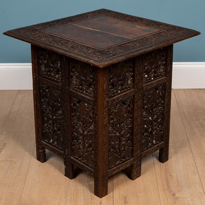 Lot 566 - An Anglo-Indian carved hardwood folding table together with a matching three-fold small screen