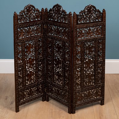 Lot 566 - An Anglo-Indian carved hardwood folding table together with a matching three-fold small screen